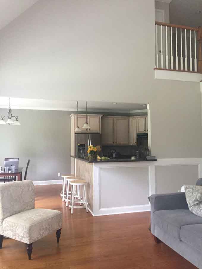 A picture of a eat-in kitchen from a living room showing new gray paint