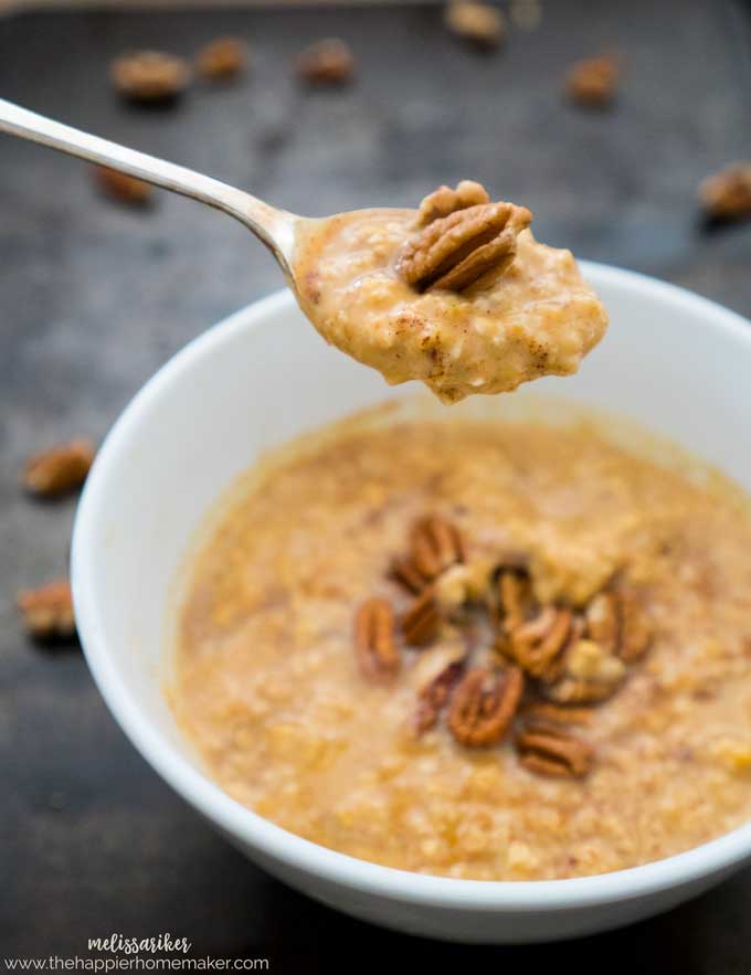 spoon of pumpkin oatmeal topped with pecans