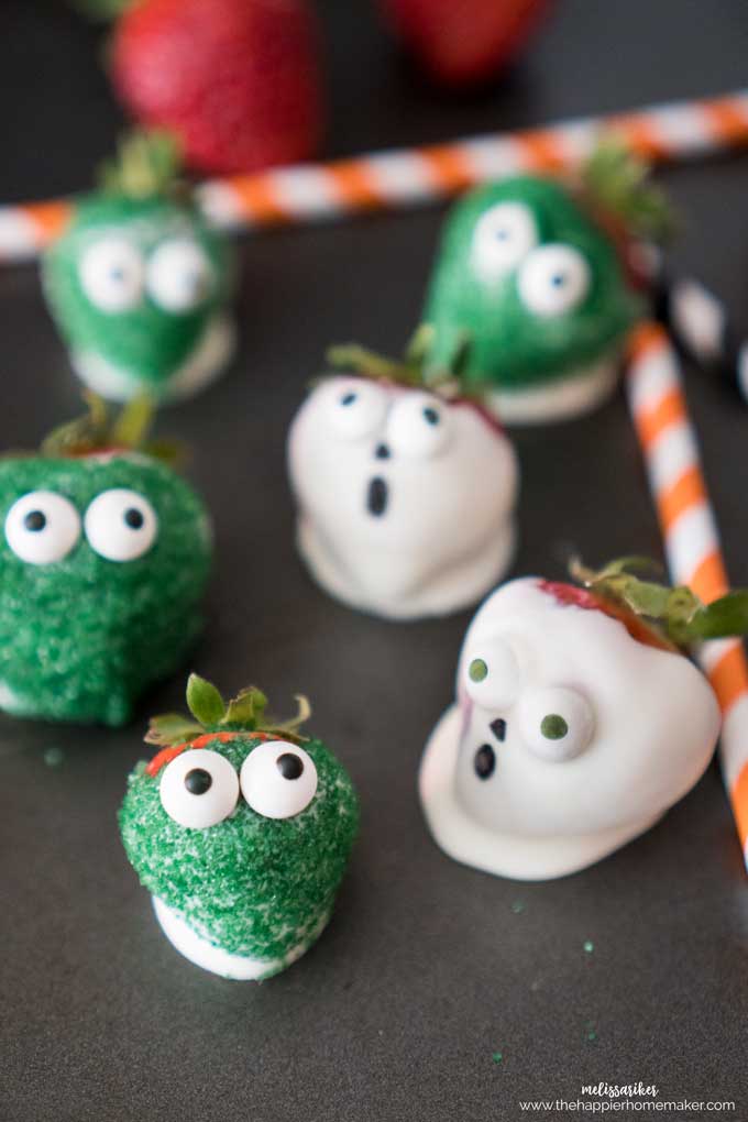 A close up of chocolate covered halloween strawberries