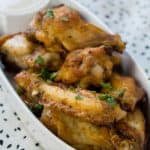 A close up of taco ranch chicken wings with green garnish