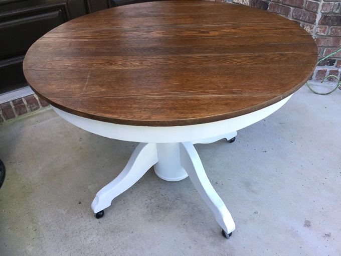 A round wooden table with white base