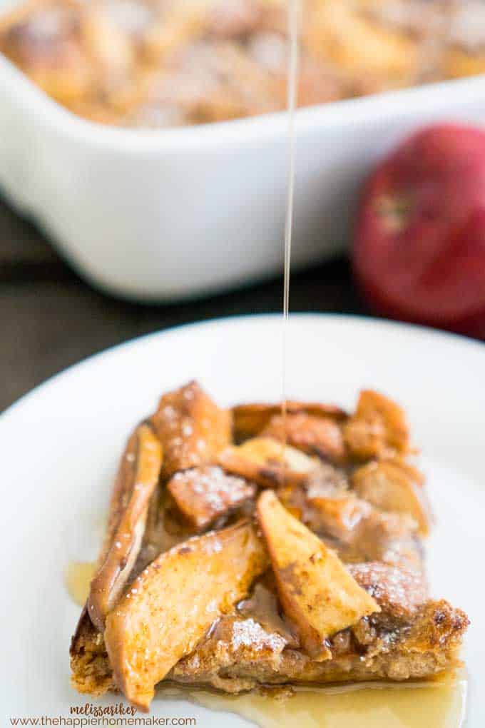 Apple Baked French Toast with syrup and powdered sugar on white plate