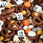 A collection of pumpkin spice snack mix with M&Ms, marshmallows and pretzels