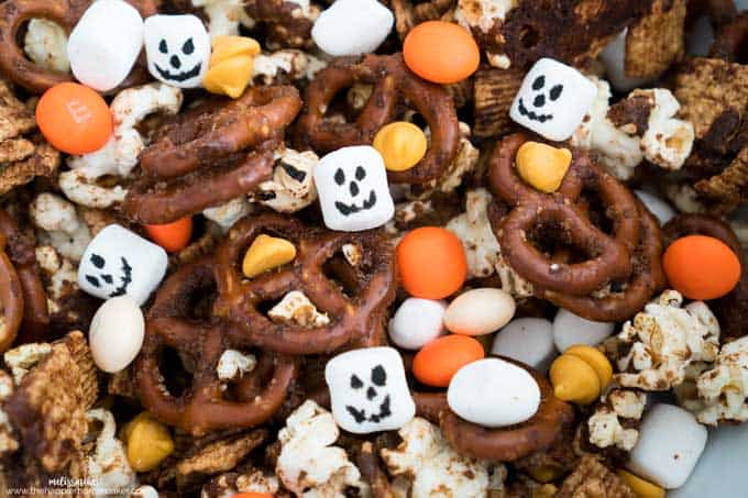 A collection of pumpkin spice snack mix with M&Ms, marshmallows and pretzels