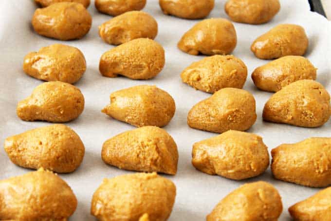 Peanut butter Oreo acorn truffles on a baking sheet before being baked