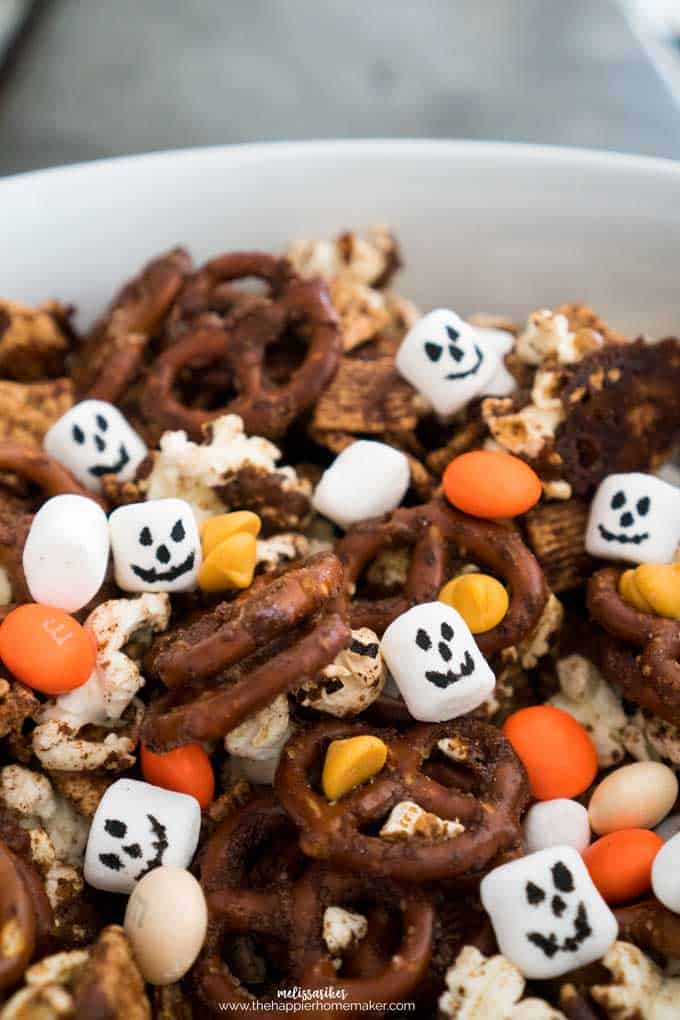 A collection of pumpkin spice snack mix with M&Ms, marshmallows and pretzels