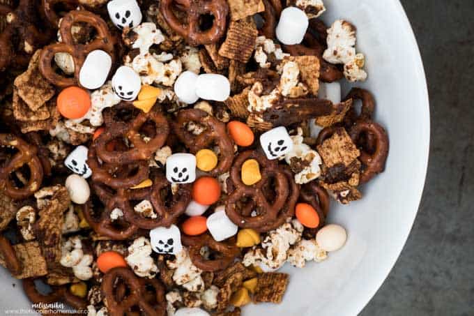 A collection of pumpkin spice snack mix with M&Ms, marshmallows and pretzels