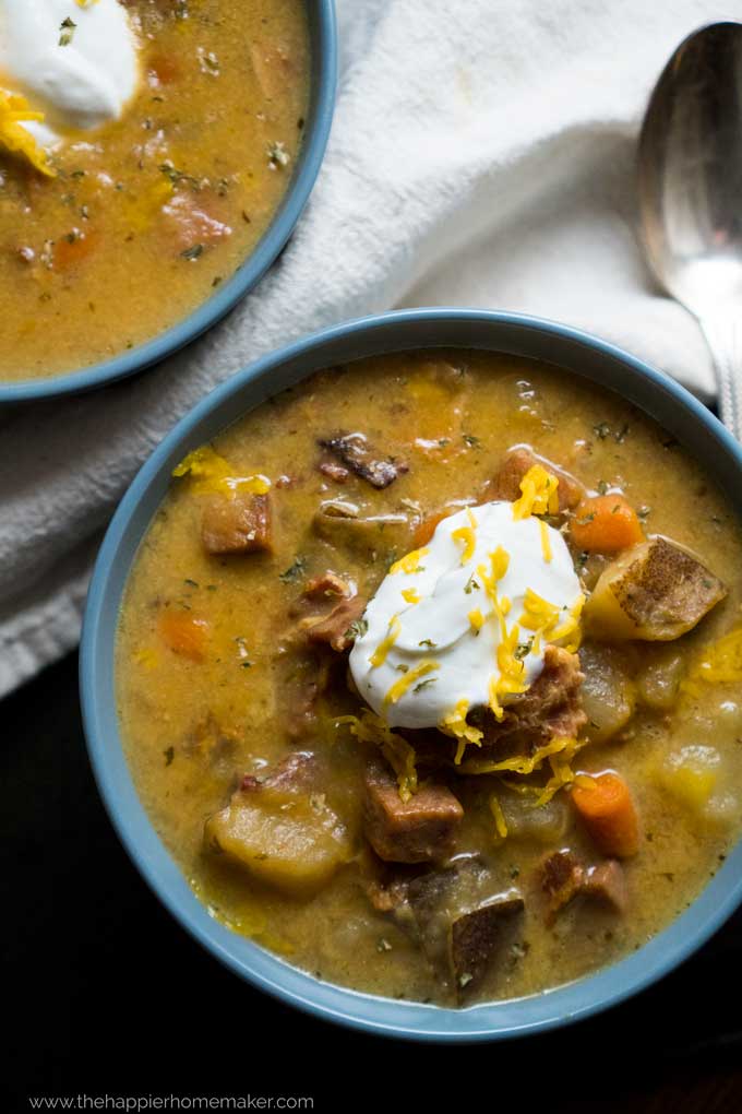 cheesy bacon ham and potato soup topped with cheese and sour cream