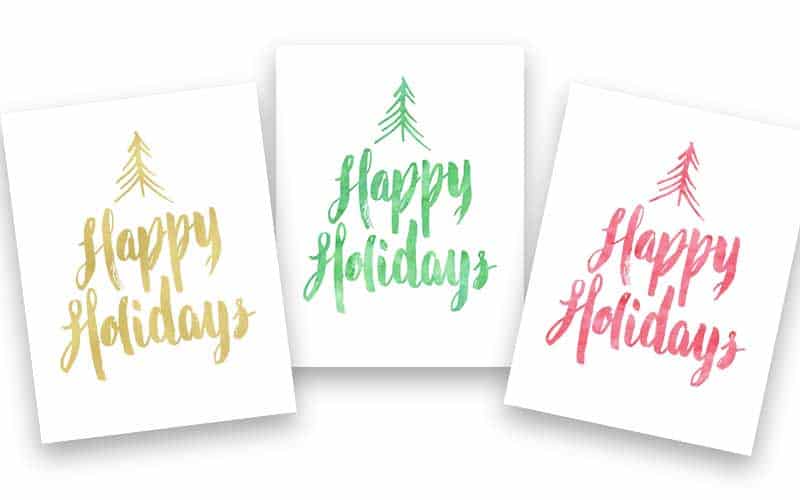 A close up of three signs that says Happy Holidays