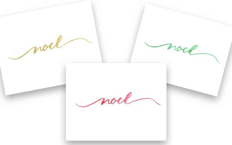 A close up of three note cards that says Noel