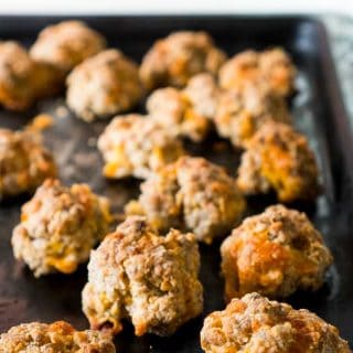 A close up of sausage cheddar balls on a baking tray