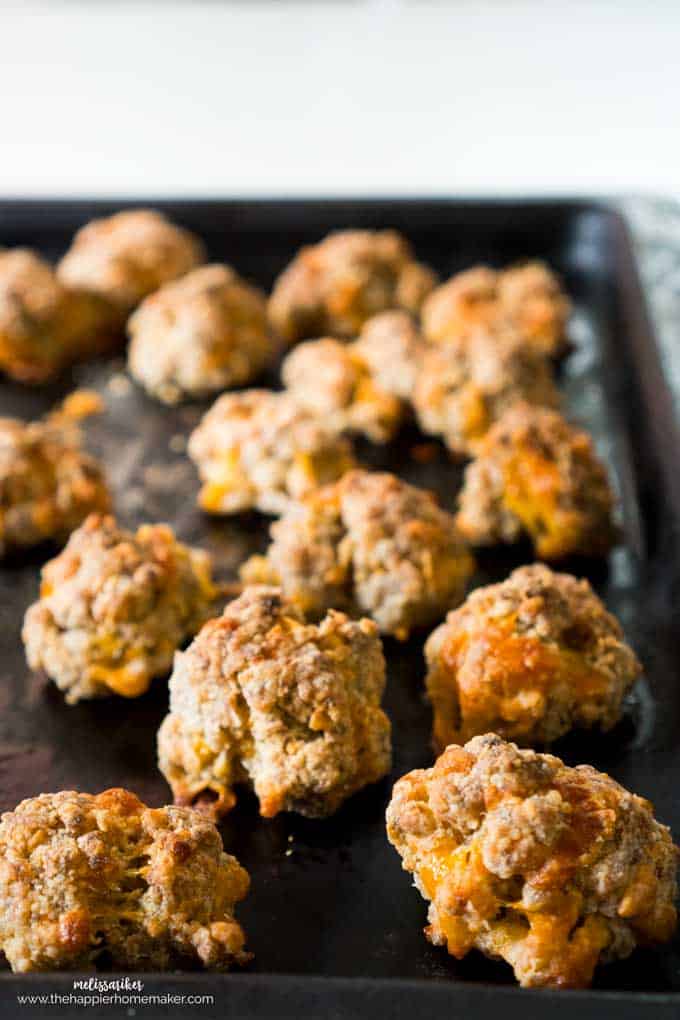 A close up of sausage cheddar balls on a baking tray