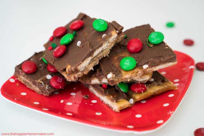 Saltine cracker toffee with red and green M&Ms on a red plate