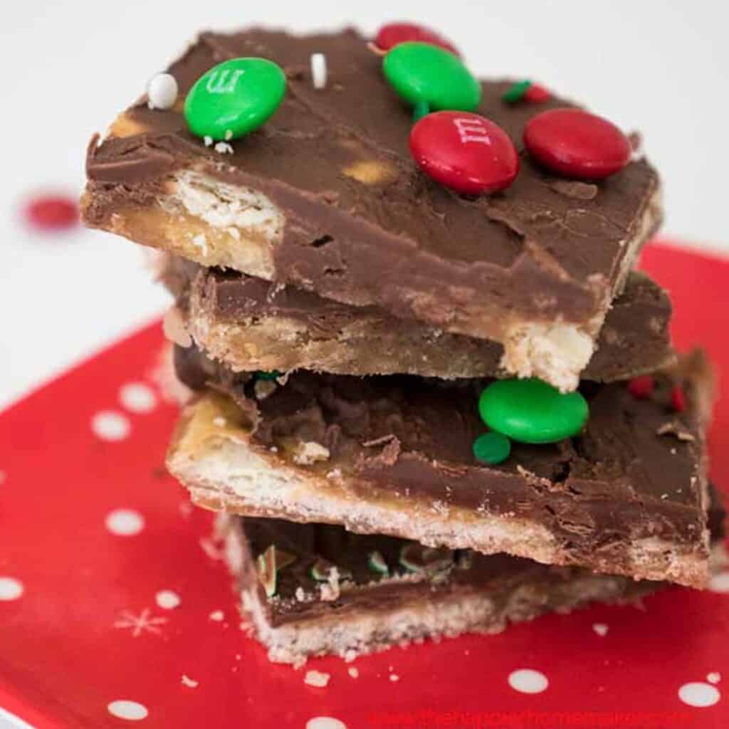 stack of christmas crack saltine toffee on red plate
