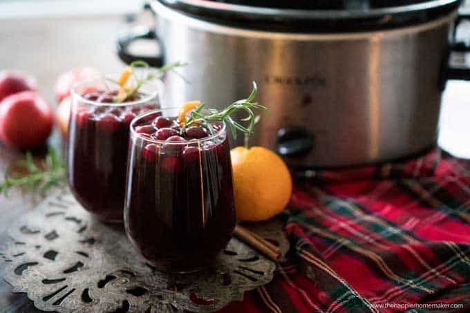Two glasses of mulled wine in front of slow cooker 