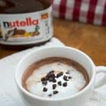 A close up of Nutella hot chocolate topped with mini chocolate chips