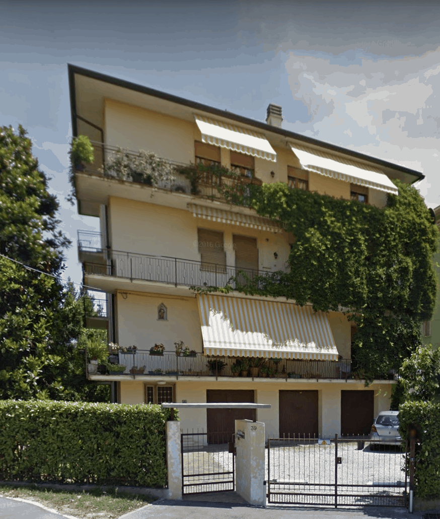 apartment building in Italy with vine growing on side