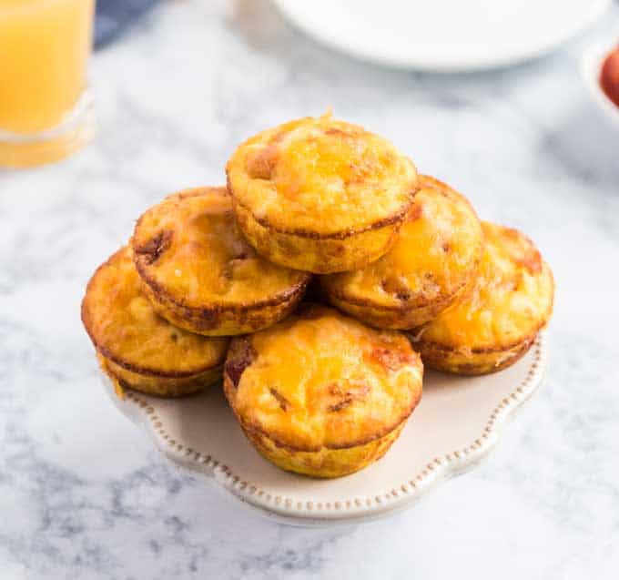 bacon cheese egg muffins on cake stand