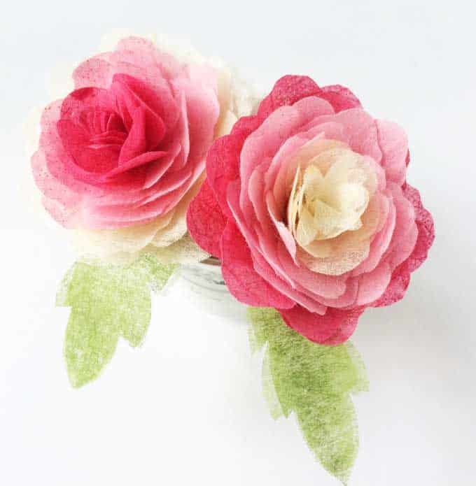 Two pink and white tissue paper flowers