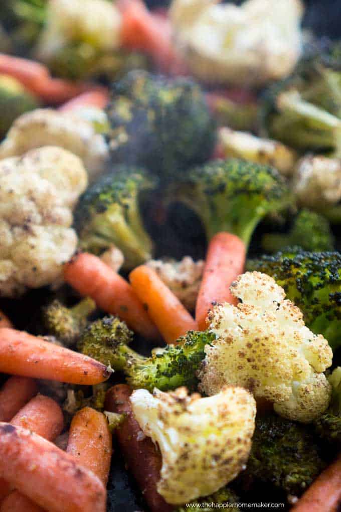 A close up of roasted vegetables including broccoli, cauliflower and carrots