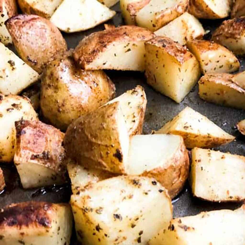 close up of Greek roasted potatoes on baking sheet