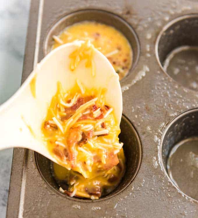scooping egg mixture into muffin tin