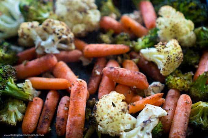 A close up of roasted vegetables including broccoli, cauliflower and carrots