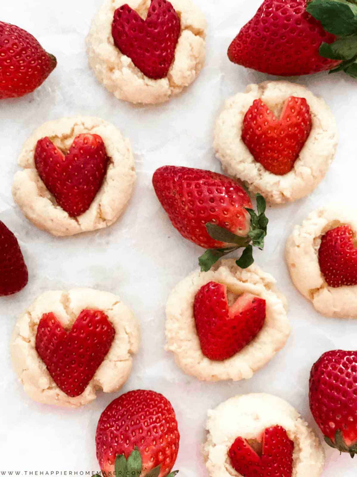 strawberry cookies with strawberries shaped like hearts from an overhead shot  