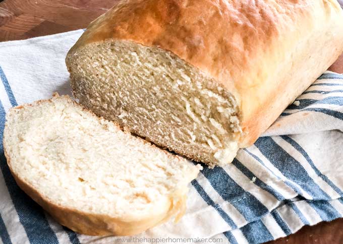 A close up of a piece of bread cut from homemade white bread loaf