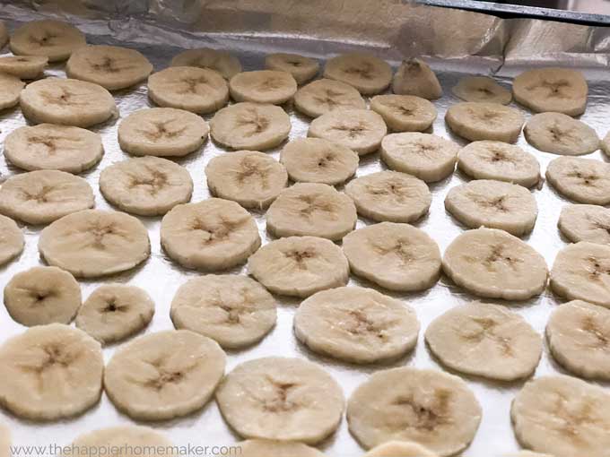 sliced bananas on foil lined baking sheet