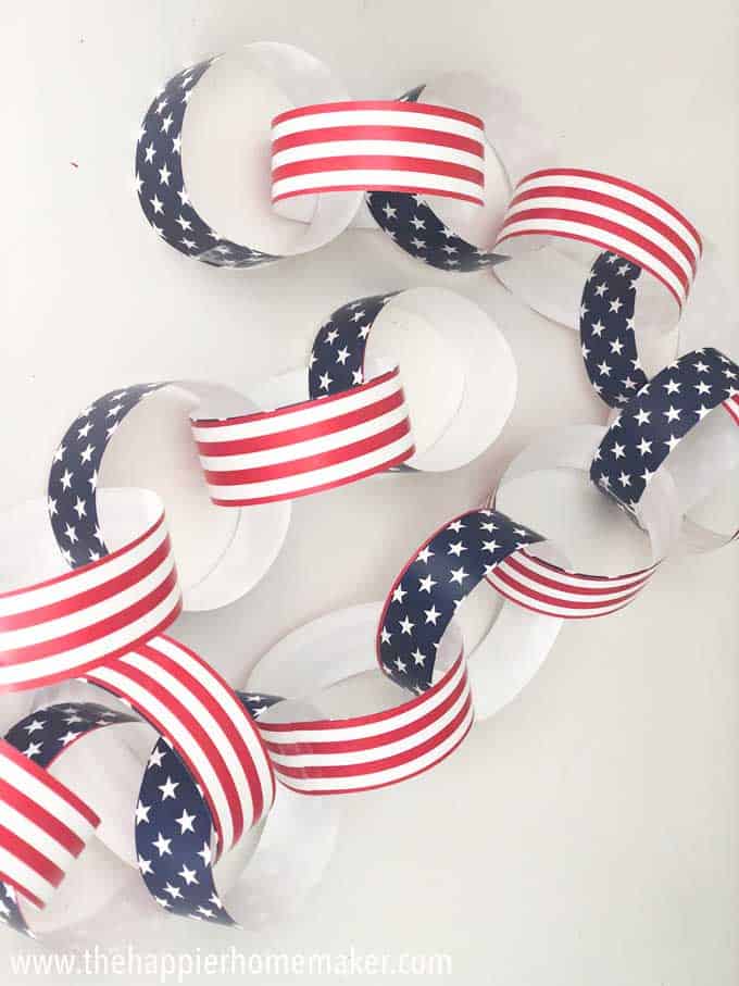 patriotic paper chain with stars and stripes on white surface