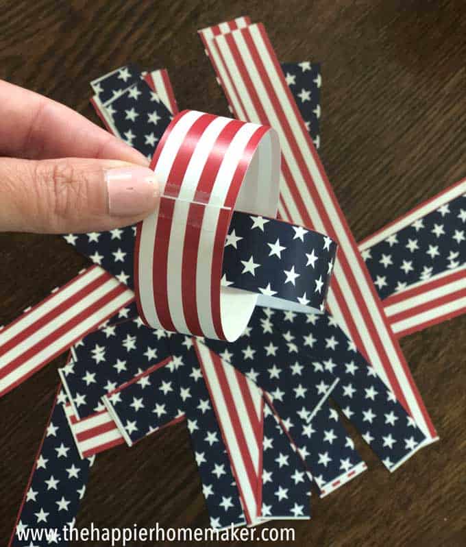 hand holding paper chain with patriotic patterns