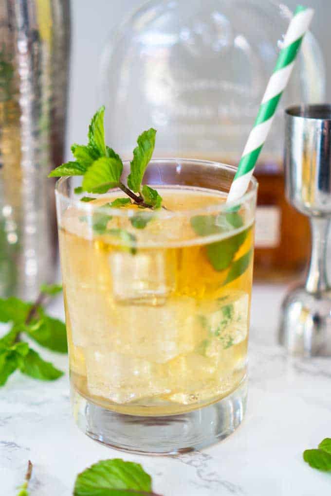 close up of mint julep in a clear glass with mint garnish 