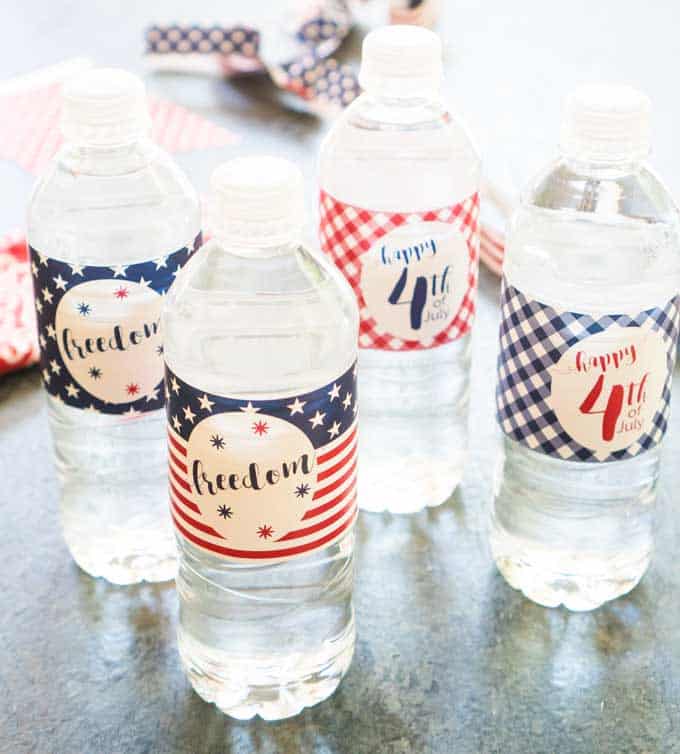 A close up of water bottles with red white and blue patriotic wraps 