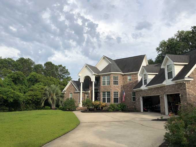 A brick house with trees in the background