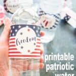A close up of a water bottle with red white and blue wrap reading freedom