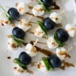 skewers with mozzarella pearls, blueberries, and basil