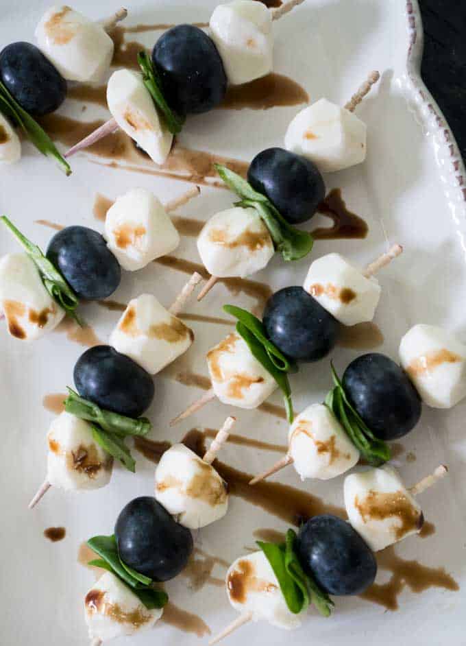 skewer with mozzarella balls, blueberries, and basil