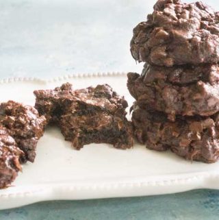 close up of chocolate cookies on white plate