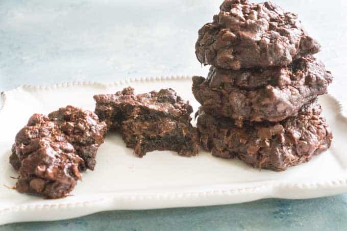 close up of chocolate cookies on white plate