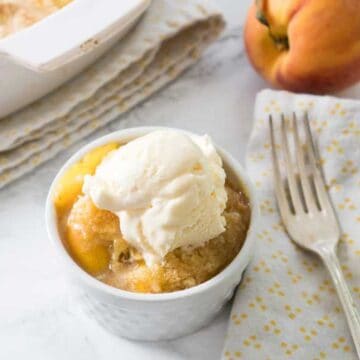 peach cobbler topped with ice cream