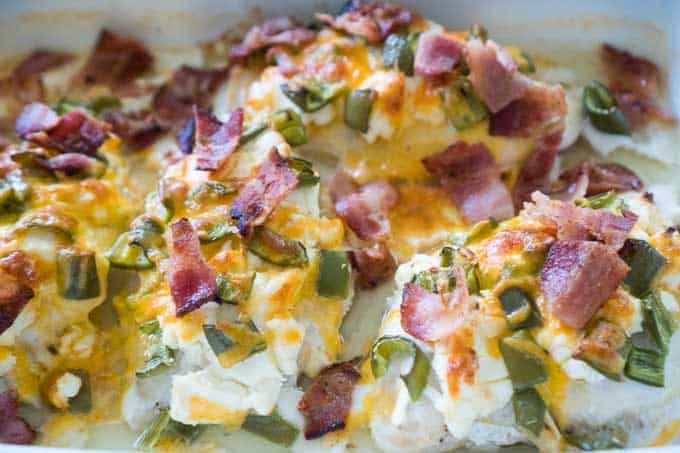 A close up of jalapeño popper chicken in white casserole dish