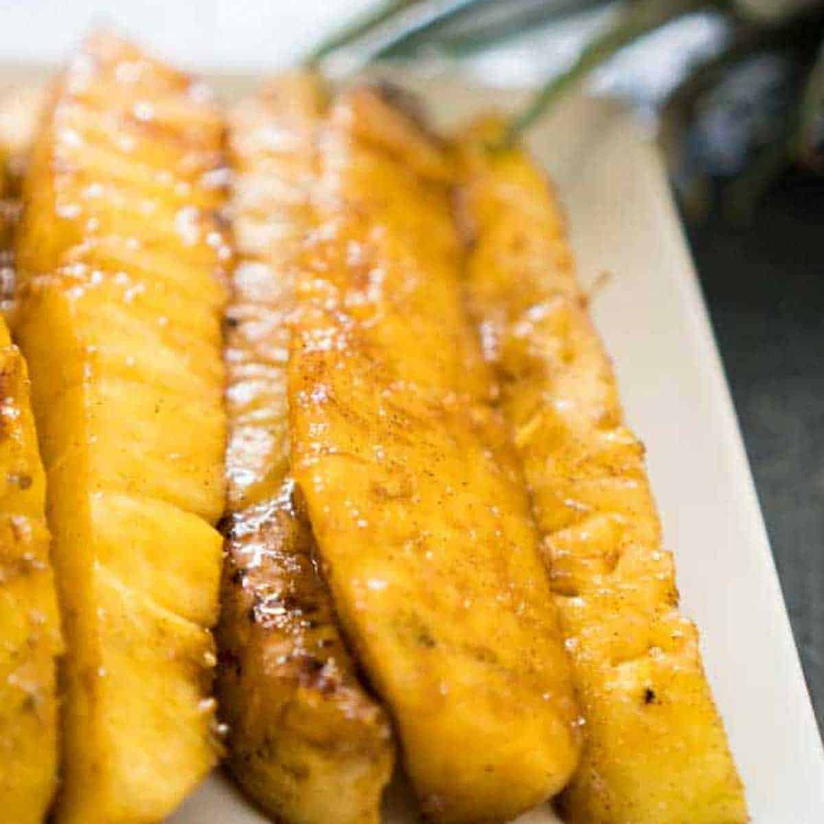 grilled pineapple spears on white plate
