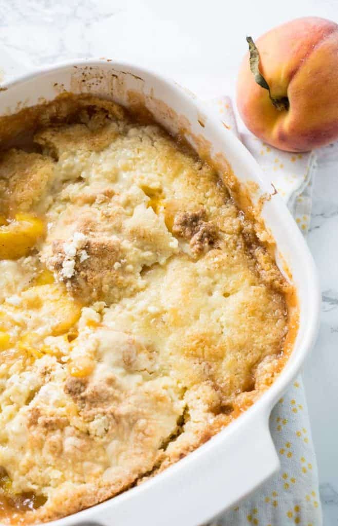 peach cobbler in white casserole dish