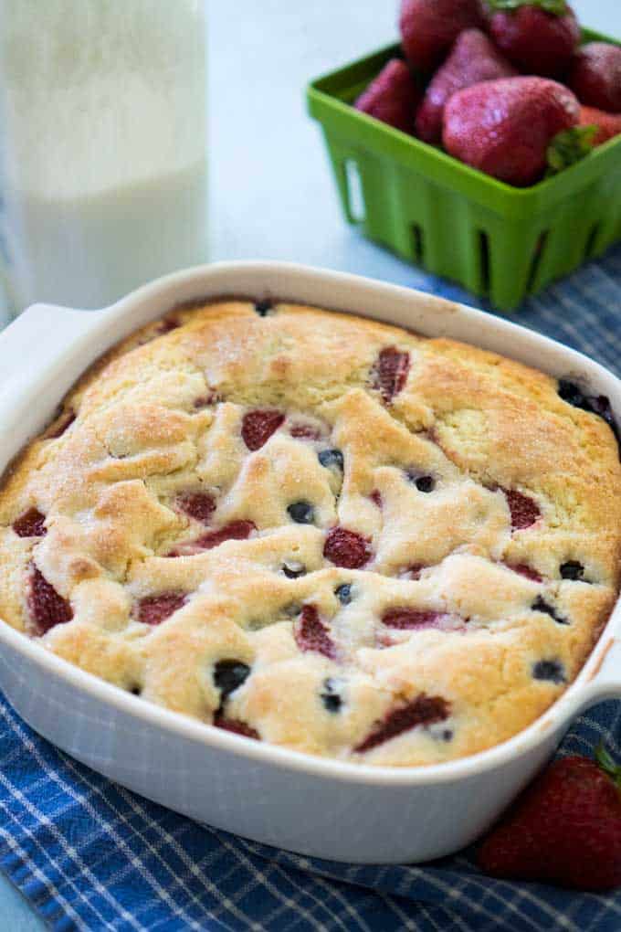 berry buttermilk cake in white square casserole dish