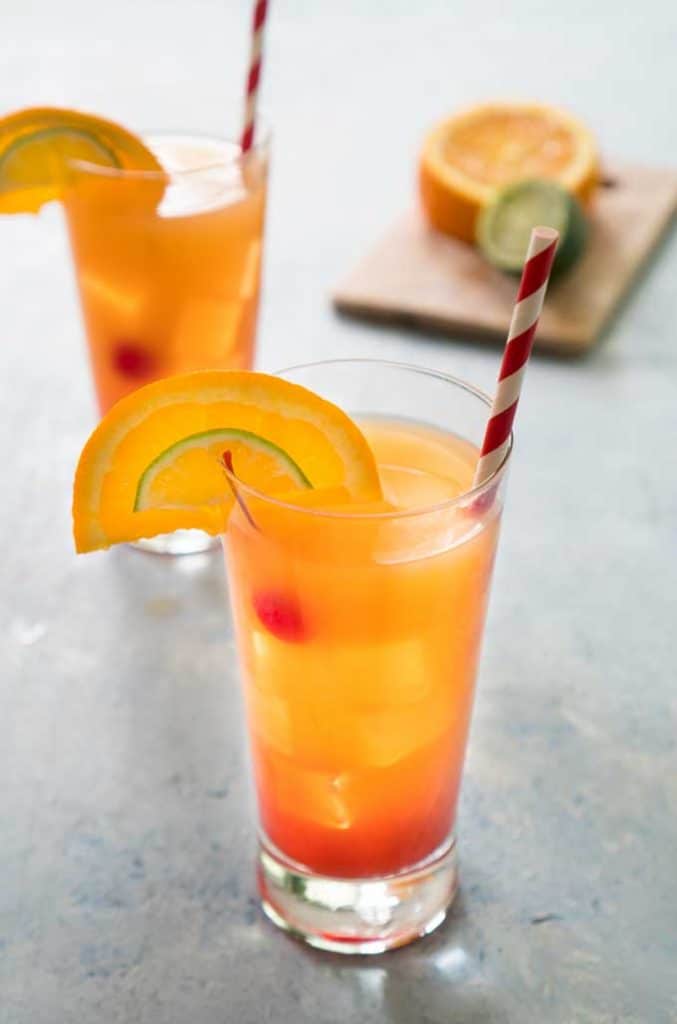 https://thehappierhomemaker.com/wp-content/uploads/2018/08/planters-punch-rum-cocktail-recipe-677x1024.jpg