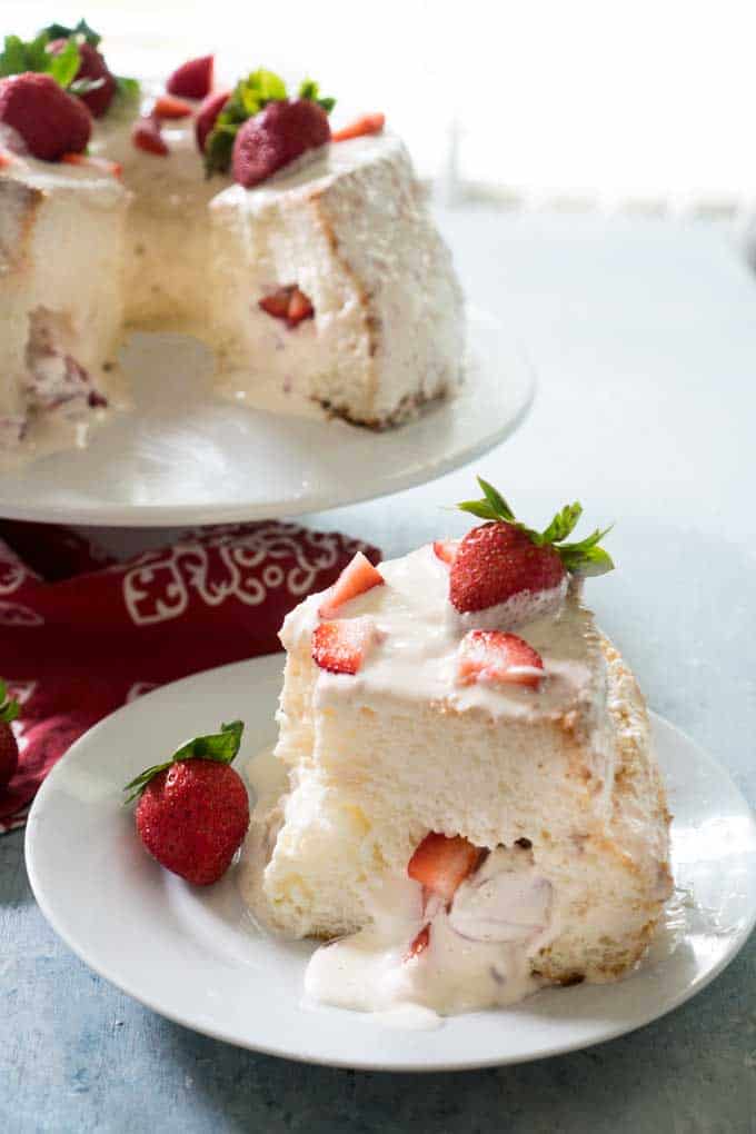 slice of strawberry stuffed angel food cake with strawberries on top