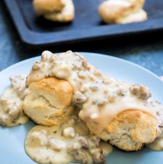 gray plate with biscuits and gravy