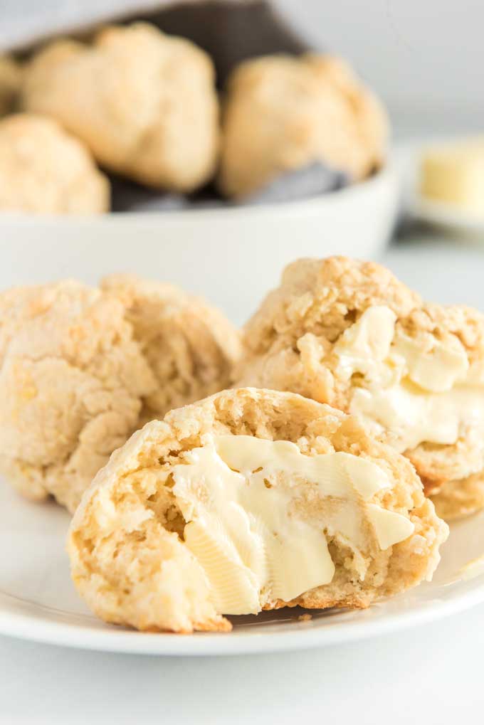 homemade biscuits with butter on white plate