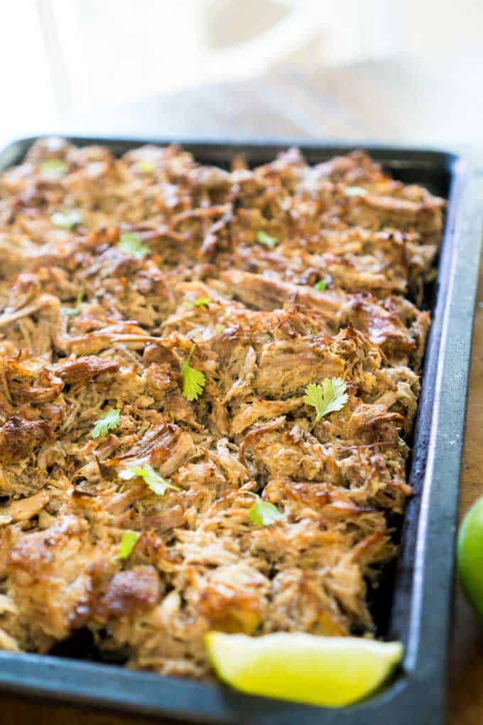 carnitas on baking sheet topped with chopped cilantro